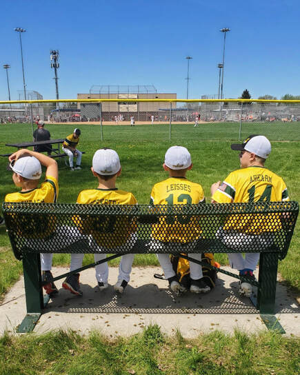 4 boys in yellow jerseys and baseball hats